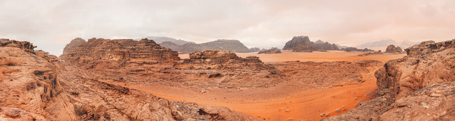 Red orange Mars like landscape in Jordan Wadi Rum desert, mountains background, overcast morning. This location was used as set for many science fiction movies © Lubo Ivanko
