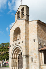 Fototapeta na wymiar Vertical shot of Santa Maria de la Oliva, beautiful romanic church at Villaviciosa, Spain.