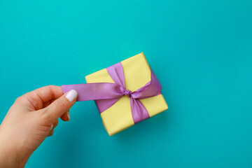  Womans hand holding Gift box on color background. Happy womens day. Happy Mothers day.Hello Spring- Image