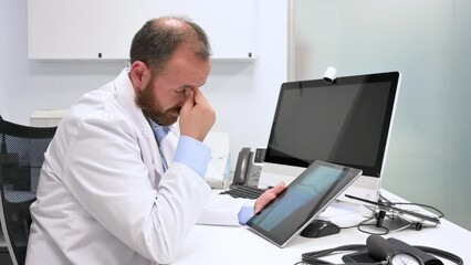 Young doctor rubbing his eyes, feeling tired and unhappy. Health care worker stress and frustration concept. High quality 4k footage
