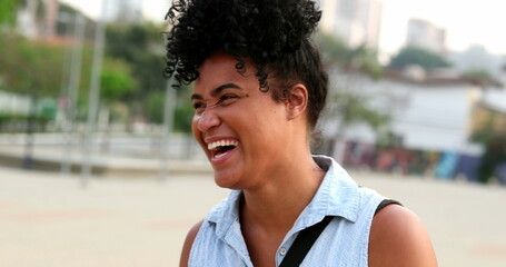 Happy young black woman spontaneous smile and laugh. Person with positive attitude