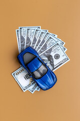 Saving money to buy a car. Toy car with money cash