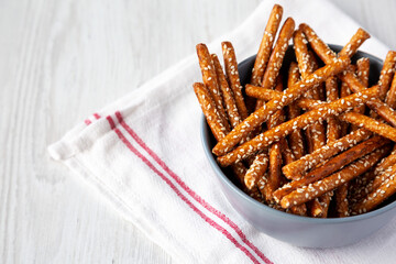 Baked Pretzel Sesame Sticks in a Bowl, low angle view. Space for text.