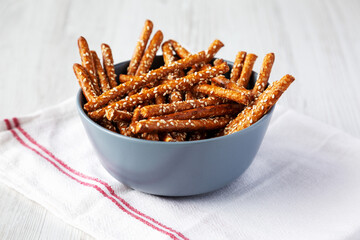 Baked Pretzel Sesame Sticks in a Bowl, low angle view.