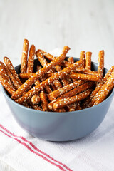Baked Pretzel Sesame Sticks in a Bowl, side view.