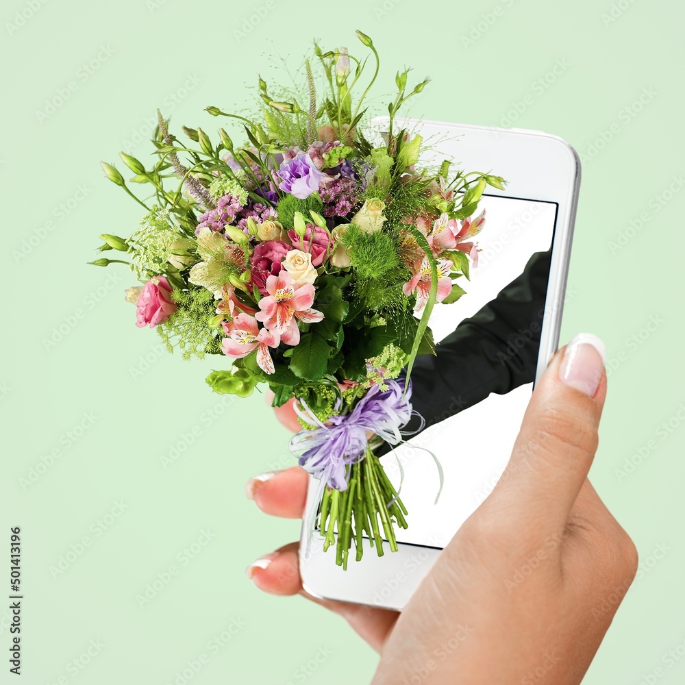 Wall mural Flowers appearing from phone screen on background. Concept of online shopping. Online order and delivery.