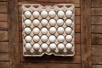 Chicken eggs in a paper tray as a background