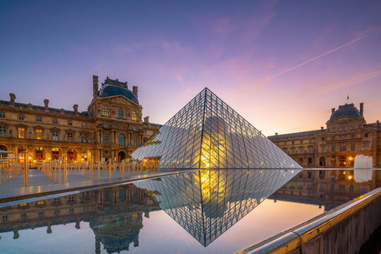 The Louvre Museum and Louvre Pyramid in Paris, France at sunrise
