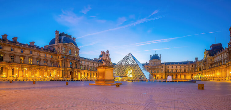 The Louvre Museum and Louvre Pyramid in Paris, France at sunrise