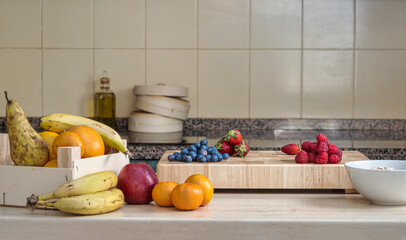 Fresh fruit in the kitchen on a wooden table for preparing a snack