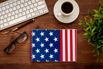 Notebook with USA flag and headphones. English lessons concept