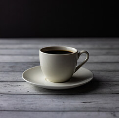 A cup of coffee, tea on a wooden table on black background