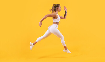 Fototapeta na wymiar energetic sport girl runner running on yellow background
