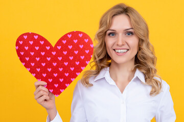 happy woman with red love heart on yellow background. charity
