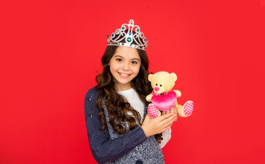 smiling child in queen crown. princess in tiara. kid hold bear toy. teen girl wear diadem