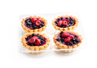 Delicious fruit tarts in plastic pack isolated on white