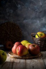 Apples with large drops of water lying in a wooden plate