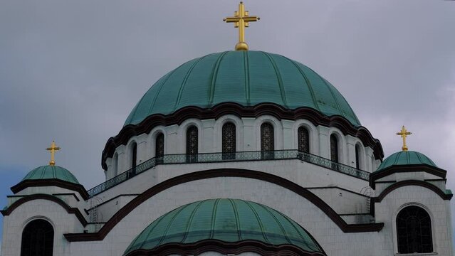 a large Orthodox marble church with three golden crosses on top of the dome
