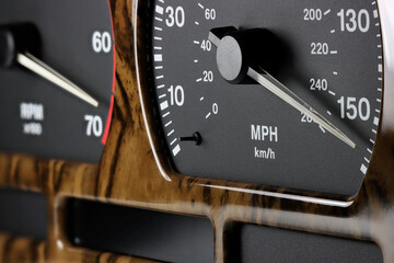 speedometer in car dashboard at full speed