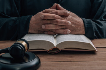 senior hands of judge with gavel and book, legislation and justice