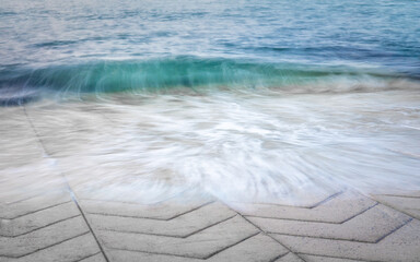 Motion Blur Of Turquoise Waves on Ridged Concrete Slipway, Ireland