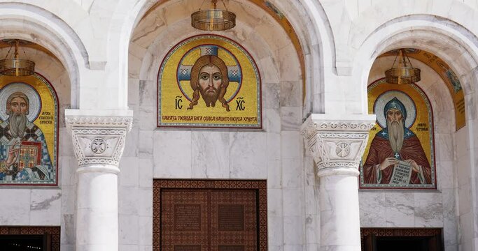 entrance to the Orthodox church of white marble with mosaic