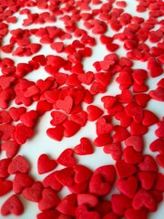 Small red hearts on a white background. Abstract background of hearts.
