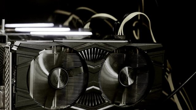 Close up details of modern mining rig with gpu, graphics cards used for creating bitcoin digital currency. Electronic devices with fans. Cryptocurrency miners.