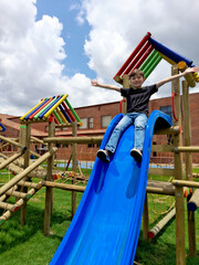Happy little boy sliding