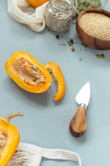 Zero waste healthy food pumpkin, seeds, vegetables, dried fruits flat lay on blue background. Groceries in textile bags,glass jars. Eco friendly plastic free low waste lifestyle.