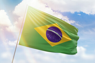 Sunny blue sky and a flagpole with the flag of brazil