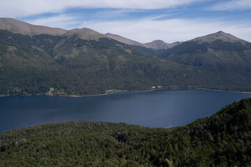 View of the forest, blue water Gutierrez lake and Catedral hill in Bariloche, Patagonia Argentina.