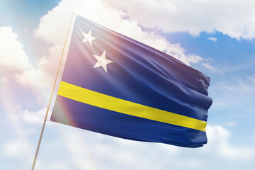 Sunny blue sky and a flagpole with the flag of curacao