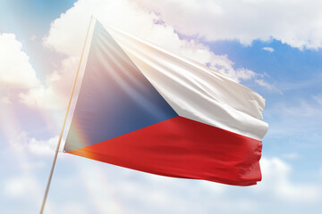 Sunny blue sky and a flagpole with the flag of czechia