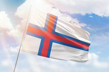 Sunny blue sky and a flagpole with the flag of faroe islands