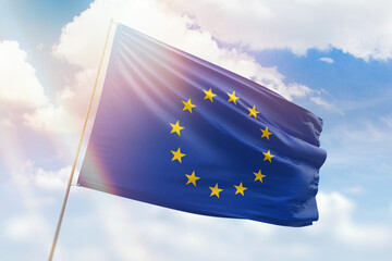 Sunny blue sky and a flagpole with the flag of european union