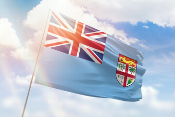 Sunny blue sky and a flagpole with the flag of fiji
