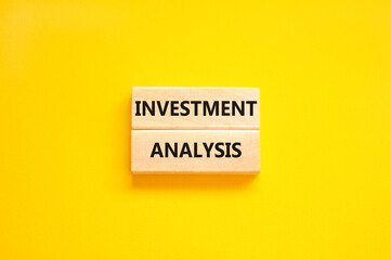 Investment analysis symbol. Wooden blocks with concept words Investment analysis on beautiful yellow background. Business investment analysis concept. Copy space.