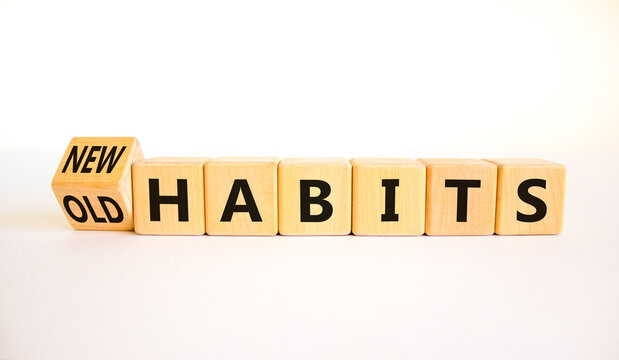 New or old habits symbol. Turned wooden cubes and changed concept words Old habits to New habits. Beautiful white table white background. Business old or new habits concept. Copy space.