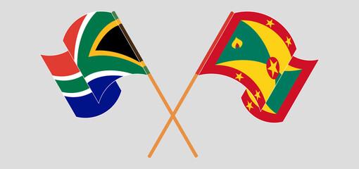 Crossed and waving flags of South Africa and Grenada