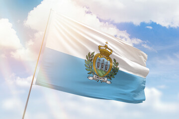Sunny blue sky and a flagpole with the flag of san marino