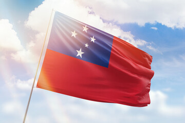 Sunny blue sky and a flagpole with the flag of samoa