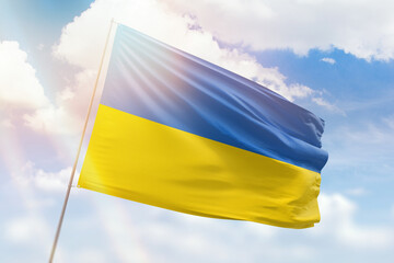 Sunny blue sky and a flagpole with the flag of ukraine