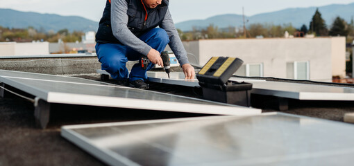 Worker installing new solar panels on roof of family house. Alternative energy. Cover photo