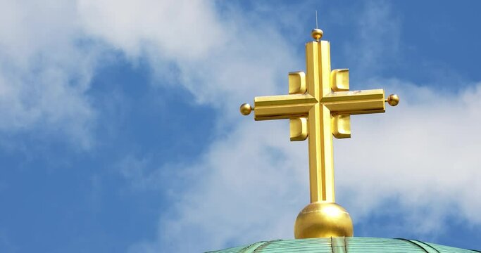 timelapse of an iron golden cross on top of a church