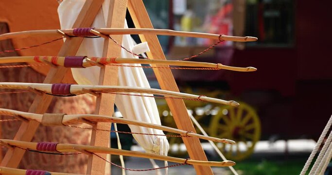 weapons bows and arrows attached to a bracket next to the tent