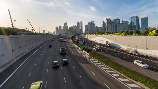 Time-lapse of car traffic transport on highway, financial district buildings, crane construction in Singapore at evening sunset. Asia transportation, commuter lifestyle, Asian city life concept