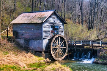 Built over 150 years ago and long since abandoned, an old wooden mill with a water wheel still sits on the banks of a peaceful stream passing through Wisconsin farmland.
