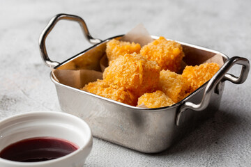 Deep fried Cheese squares served with cranberry sauce. Delicious homemade appetizer.