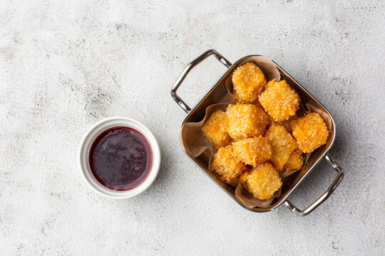 Deep fried Cheese squares served with cranberry sauce. Delicious homemade appetizer.